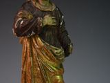 a statue of a man with a hat and a robe