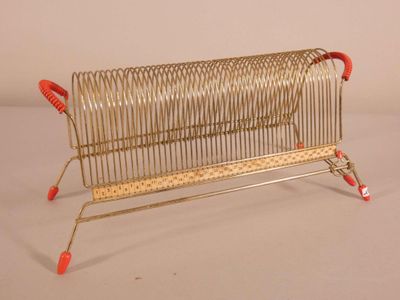 a small metal rack that has a red handle on it
