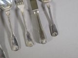 a lot of spoons and forks that are on the table
