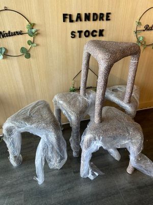 three chairs and a stool made out of plastic wrap