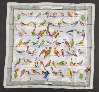 a close up of a square scarf with birds on it