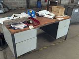an image of a desk with a lot of clutter on it