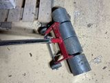 a clamp that is laying on the floor next to a piece of wood
