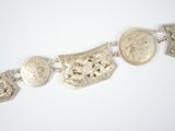 an image of a bracelet made of silver coins and silver charms