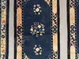 three oriental rugs on display on a table in a room