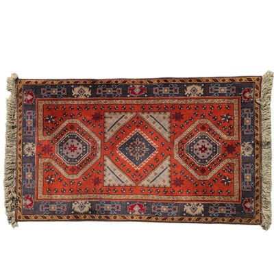 an orange and blue rug with a diamond design on it