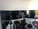 a photo of a computer room with two monitors and a desk
