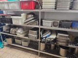 a kitchen with a lot of dishes and pans on the shelves