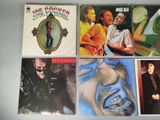several different album covers of a man and a woman on a white surface