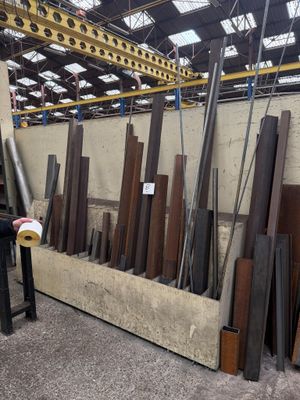 a man that is standing in front of a pile of wood