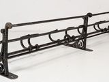 a metal bench that is sitting on a white floor