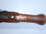 an old gun with a wooden body and a metal handle