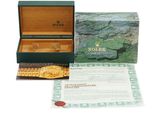 a rolex watch in a box with a certificate in it