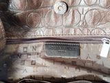 the inside of a brown purse with a tag on it