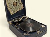 an old record player in a case with a key