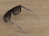 a pair of sunglasses sitting on a wooden table