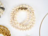 many different types of jewelry on a white surface