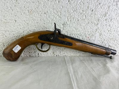 an old gun with a wooden handle on a white surface