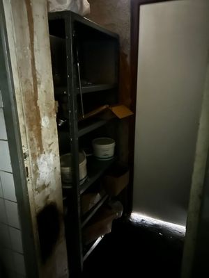 a refrigerator and a microwave in a small room
