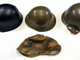 three helmets and a hat sitting on top of a white surface