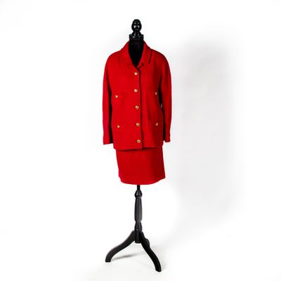 un manteau rouge sur un mannequin, posé devant un fond blanc
