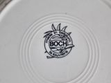 a white plate with a black and white logo on it