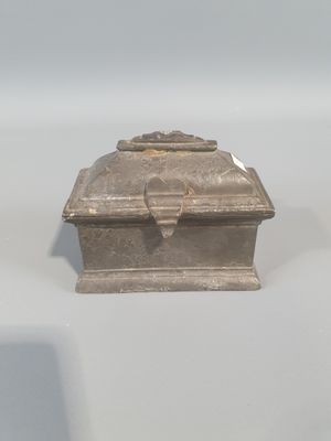 a small silver box sitting on top of a table