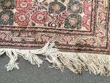 a rug on the ground with a cat laying on it