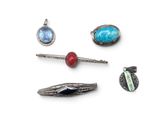 several pieces of jewelry are arranged on a white surface