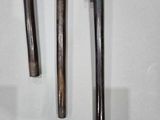 two old hammers hanging on a wall next to each other
