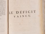 an open book with the words le deficit written on it