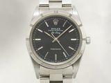 une photo d'une montre Rolex à cadran noir montée sur un bracelet