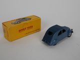 an old toy car is next to a boxed box on a white surface