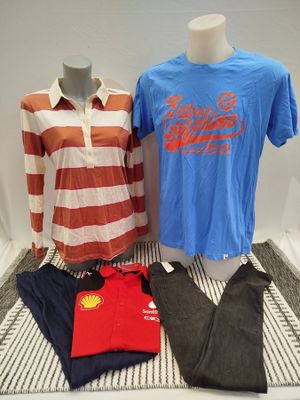 two men ' s shirts and pants are on display in a display case