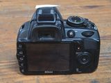a black camera sitting on a wooden table