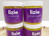 three jars of lizie ' s ultimate lip butter sitting on top of a wooden tray