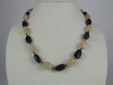 necklace with black and white beads on a white mannequin