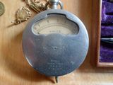 une horloge posée sur une table à côté d'autres objets