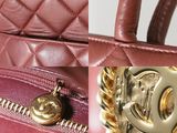 a close up of a handbag with a chain on it