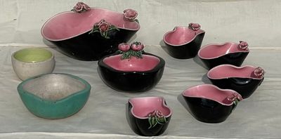 many bowls and bowls sitting on a table with a white cloth