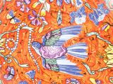 an orange plate with a bird and flowers on it