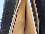 the inside of a black purse with a zipper open