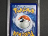 a close up of a pokemon card on a black surface