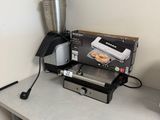 a coffee maker and a blender sitting on a table