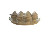 a tray that has a tray with four different teapots on it