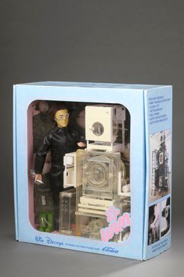 a toy robot in a box that is sitting on a table