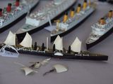 a lot of model ships that are on a table