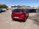 a red car that is parked in a parking lot