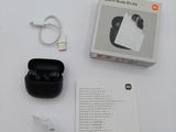 a box of earphones and a charger on a table