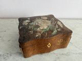 a small wooden box with a floral design on it